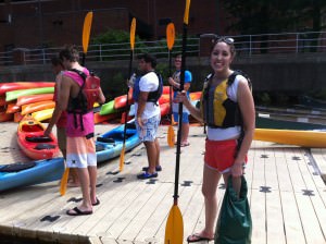 Alli & students are given paddles & kayaks
